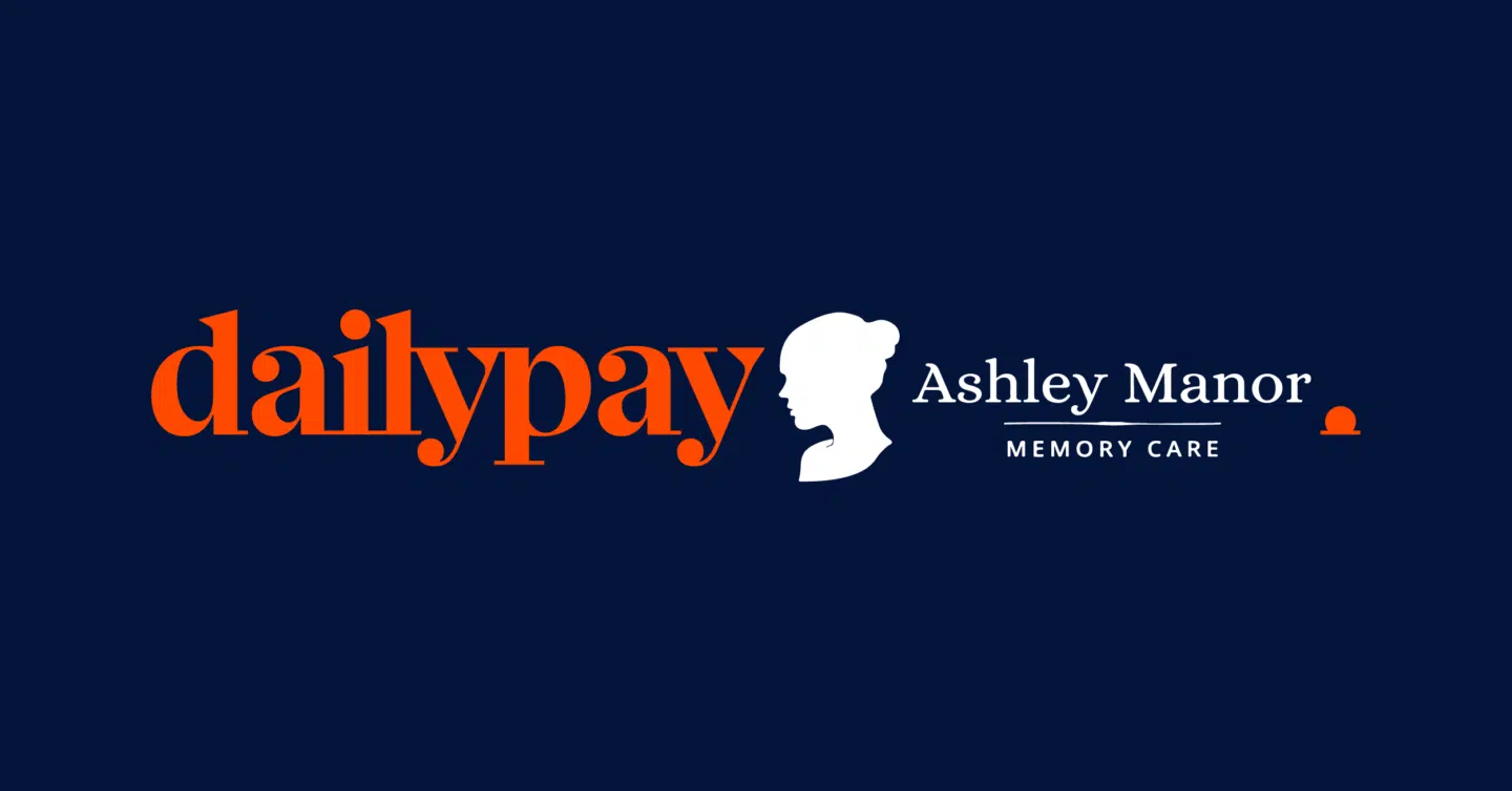 The image features a logo with the text "dailypay" in bold, orange serif letters. To the right, there is a white silhouette of a woman's profile followed by the text "Ashley Manor MEMORY CARE" in white. The background of the image is dark blue.
